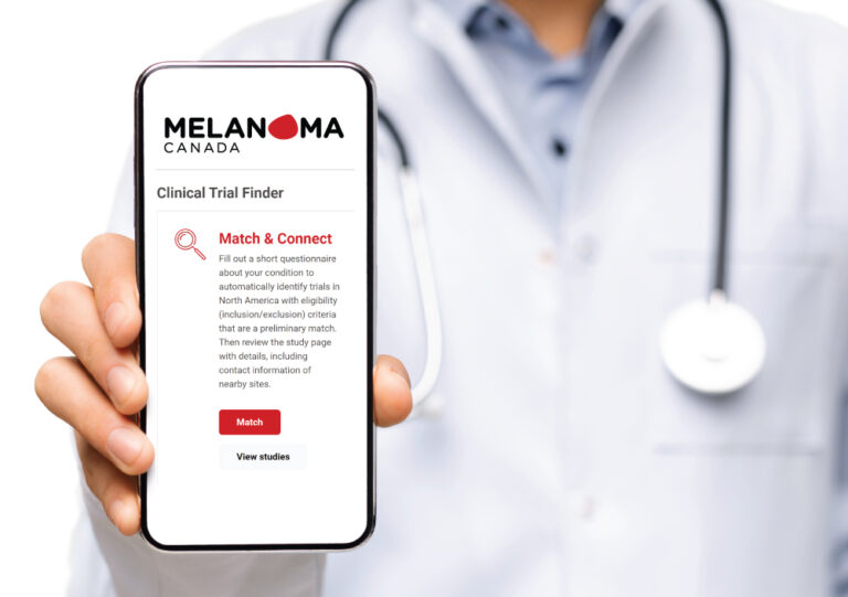doctor holding phone with clinical trial finder website showing